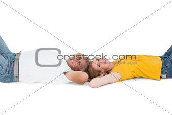 Casual couple lying on floor