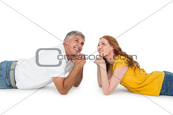 Casual couple lying on floor