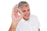 Casual man showing ok sign to camera
