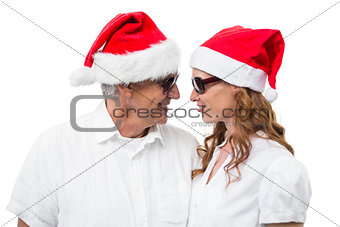 Festive couple smiling at each other