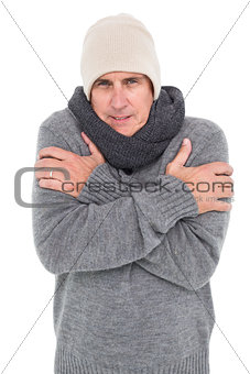 Casual man shivering in warm clothing
