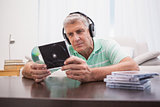 Mature man listening to cds