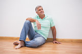 Mature man sitting on floor