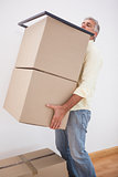 Man balancing heavy cardboard boxes