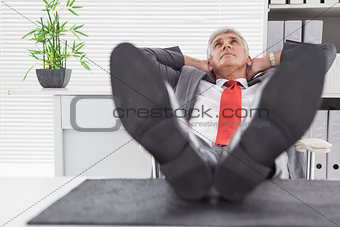Relaxed businessman with his feet up
