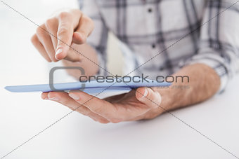 Casual businessman using tablet at desk