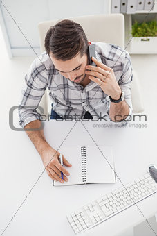 Casual businessman looking at notepad