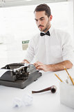 Hipster businessman using a typewriter