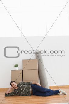 Happy man posing with moving boxes