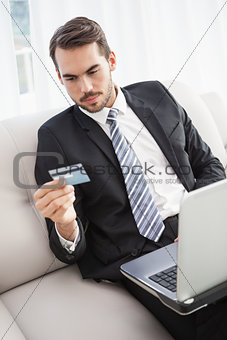Businessman shopping online on his couch