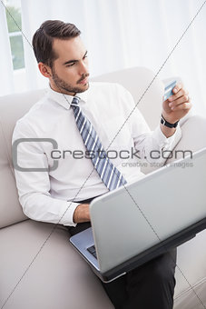 Businessman shopping online on his couch