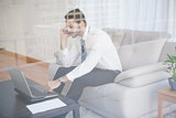 Businessman working on his couch seen through glass