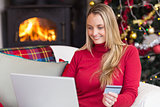 Woman doing online shopping with laptop and credit card