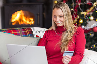 Woman doing online shopping with laptop and credit card