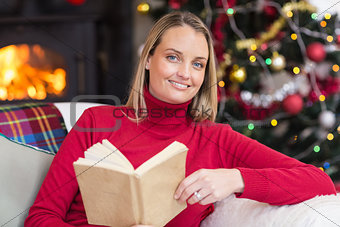 Smiling blonde reading on the couch