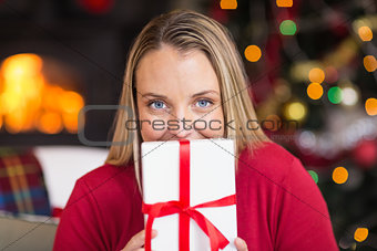 Pretty blonde woman holding christmas gift