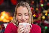 Pretty blonde enjoying a hot drink at christmas