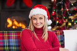 Portrait of a smiling blonde wearing santa hat
