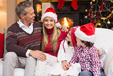Portrait of a smiling family sitting on sofa at christmas time