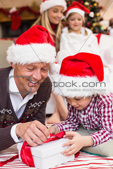 Festive father and son opening christmas present