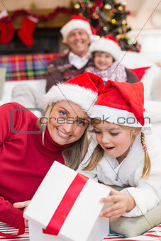 Surprised mother and daughter opening a christmas gift