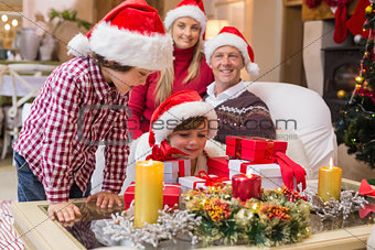 Smiling family at christmas time with lots of presents