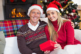 Festive couple holding christmas gifts