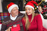 Loving couple in santa hat with gift