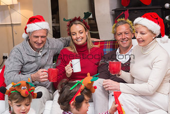 Happy extended family enjoying coffee at christmas time