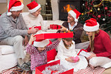 Happy family opening christmas gifts together