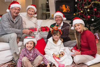 Happy family at christmas holding gifts