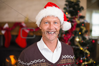Portrait of a smiling handsome man in santa hat
