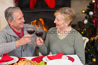Senior couple toasting red wine