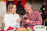Couple toasting each other with red wine