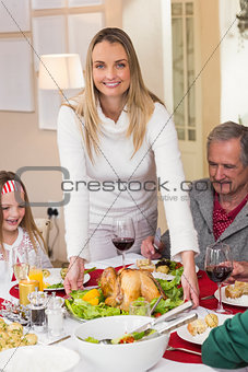 Woman serving roast turkey at christmas