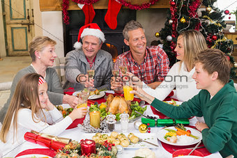 Extended family toasting at christmas dinner