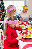 Little girl in party hat holding christmas crackers