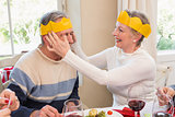 Smiling mature couple in party hat