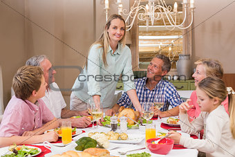 Woman serving christmas dinner to her family