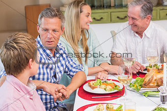 Family speaking together at christmas dinner
