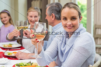 Woman smiling at camera while holding a glass of wine