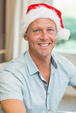 Portrait of handsome man in santa hat