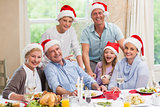 Happy family in santa hat looking at camera