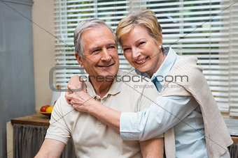 Senior couple smiling at the camera together