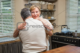 Senior couple hugging and smiling