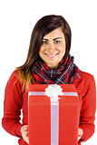 Smiling brunette holding a gift with white bow