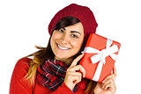 Smiling brunette in red hat holding gift