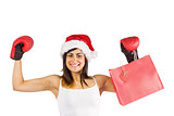 Festive brunette in boxing gloves holding shopping bags