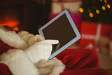 Santa claus touching tablet pc