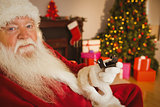 Father christmas holding engagement ring with his box